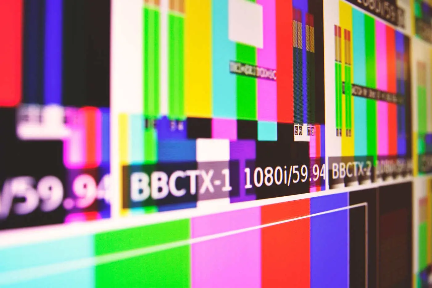 A colorful television test card pattern is displayed, indicating various technical details such as resolution and broadcaster information.