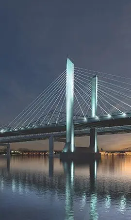 Cable suspension bridge over a river at night