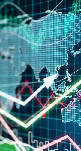 A screen displays a rising stock market graph with various global indexes, highlighting financial growth against a world map backdrop.