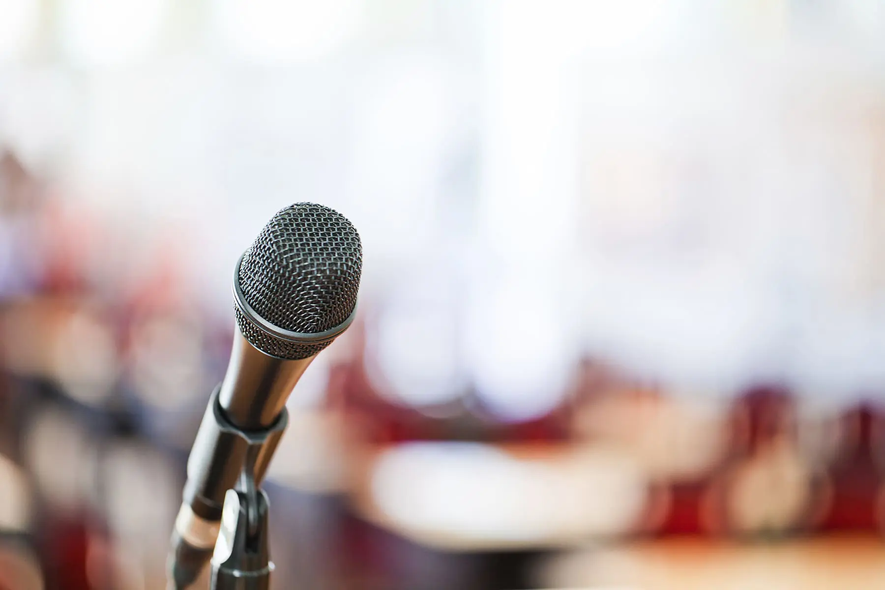 Close-up of a microphone at a government meeting, symbolizing public hearings and municipal legal services.