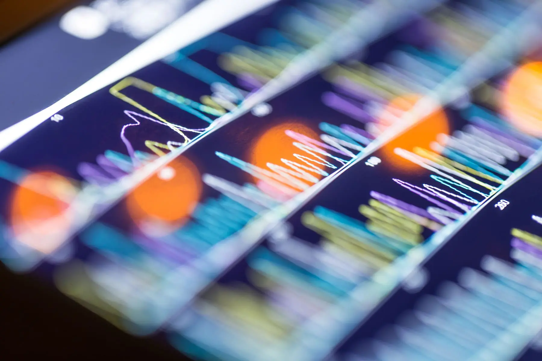 A close-up view of a smartphone displaying colorful graphs and analytics data.