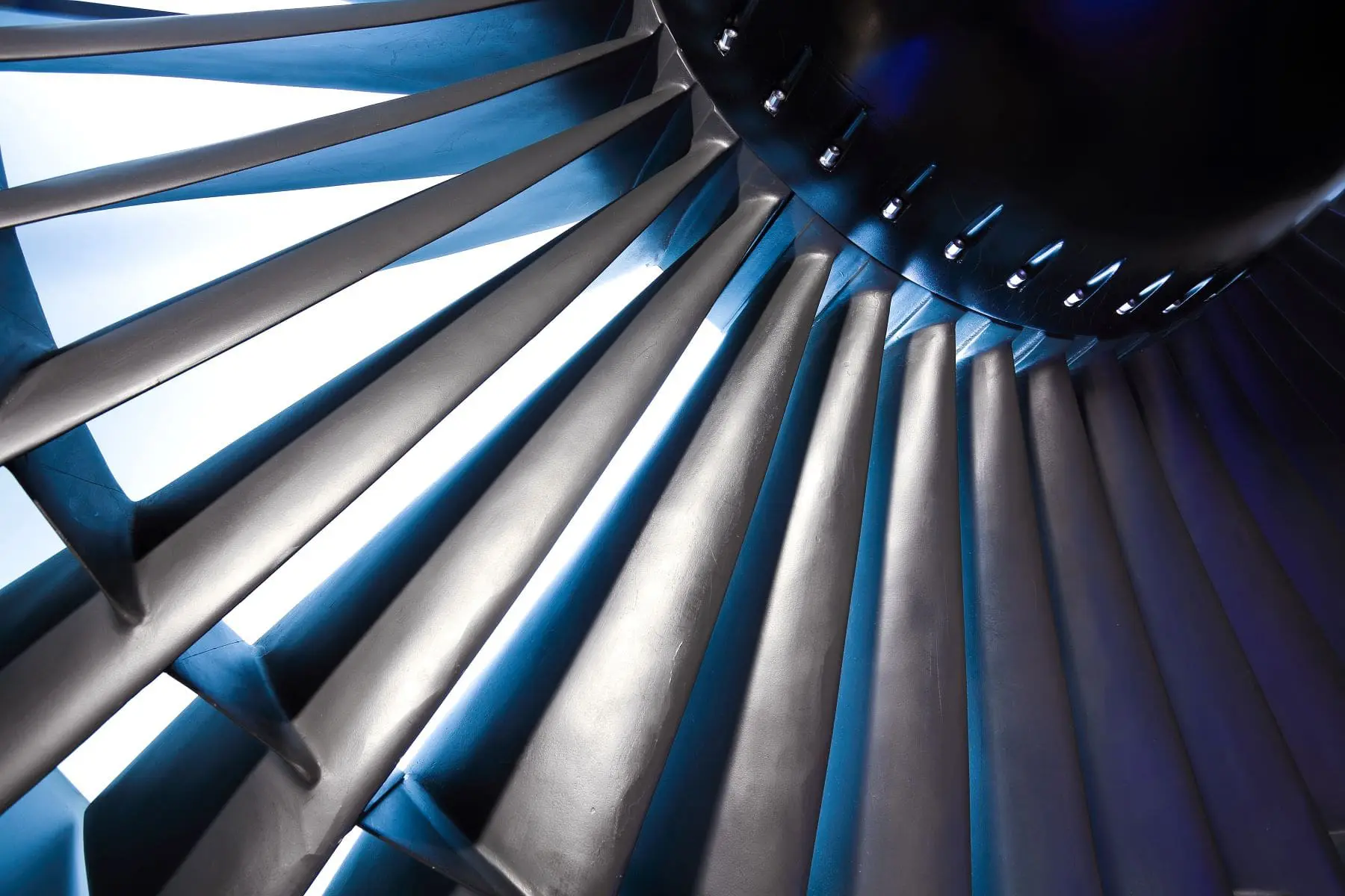 A close-up view of a jet engine turbine blades with dynamic lighting and shadows.