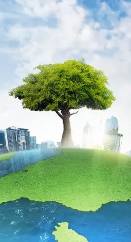 A solitary tree stands at the center of a grassy continent, juxtaposed with an encircling urban skyline against a backdrop of a clear sky with fluffy clouds.