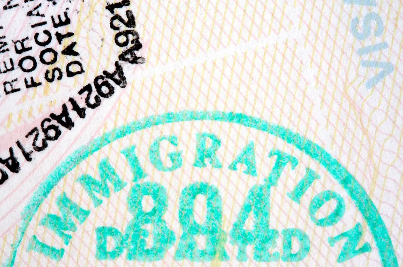 A close-up of a document shows a stamped text "IMMIGRATION" alongside other obscured text and stamp markings.