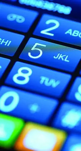 A close-up view of a cellphone keypad with illuminated blue buttons displaying numbers and corresponding letters.