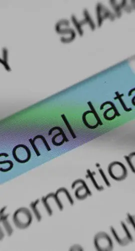 A magnifying glass is highlighting the words "personal data" on a document.