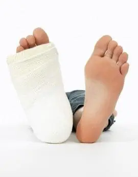 One bare foot and one foot with a white sock against a white background.