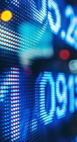 Display Stock Market Numbers With Defocused Street Lights Background