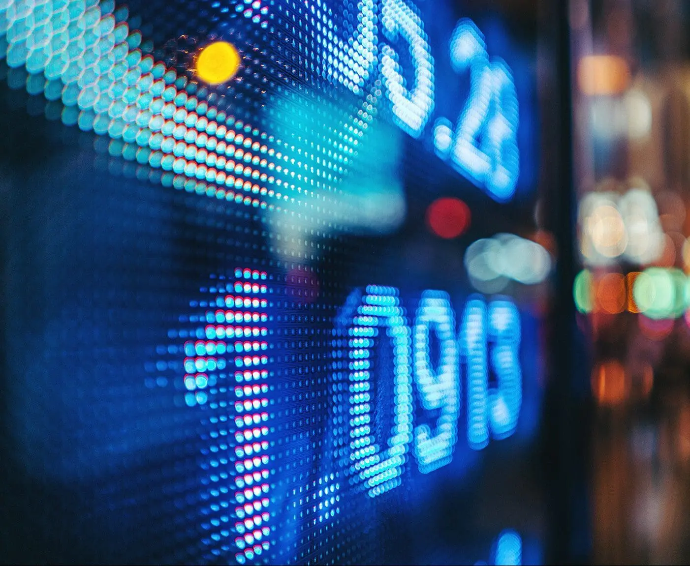 Display Stock Market Numbers With Defocused Street Lights Background