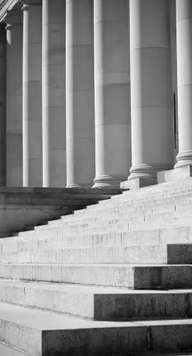 black and white image of government building pillars