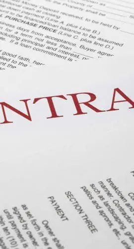 A contract document with bold red text and various clauses and sections visible.