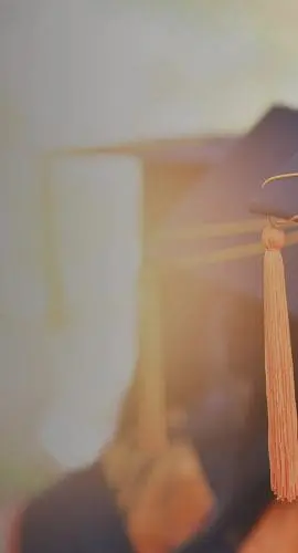 Two graduation caps with tassels are visible from behind.