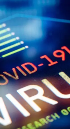 A digital display shows the word "COVID-19" along with virus-related data and various graphical elements.