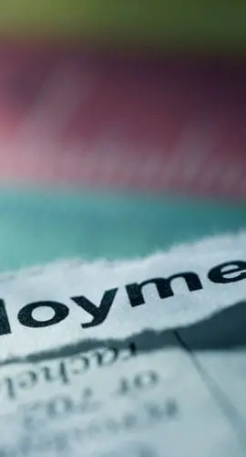 A torn piece of paper with the word "Employment" printed on it is prominently displayed.