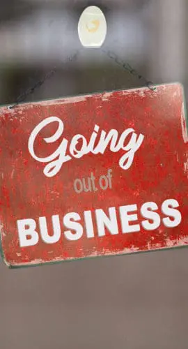A red sign with white text reading "Going out of BUSINESS" is displayed on a glass door.