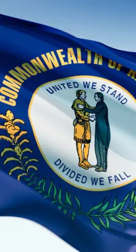 A flag with "Commonwealth of Kentucky" and "United We Stand, Divided We Fall" surrounding a seal depicting two men shaking hands.