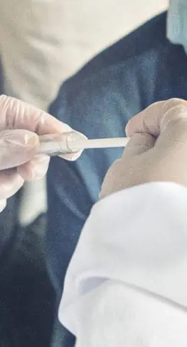 A doctor in a protective suit performs a Coronavirus test for the Covid-19 virus.pandemic concepts