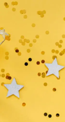 Golden statuette and stars on yellow background