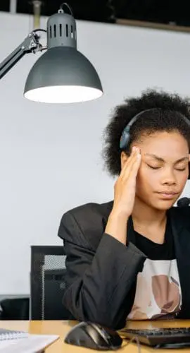 A tired woman massaging her head
