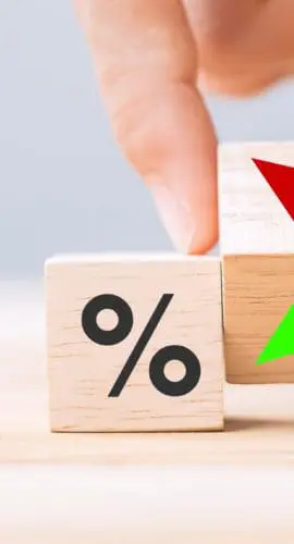business man Hand change wood cube block with percentage to UP and Down arrow symbol icon. Interest rate, stocks, financial, ranking, mortgage rates and Cut loss concept