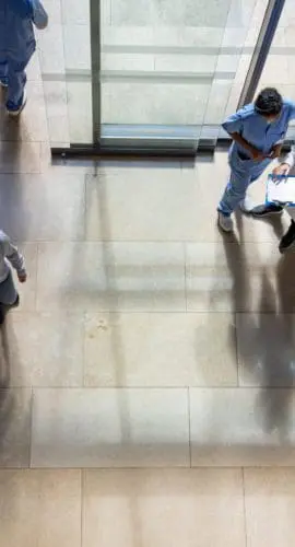 Latin American patients and doctors coming in and out of the hospital - healthcare and medicine concepts