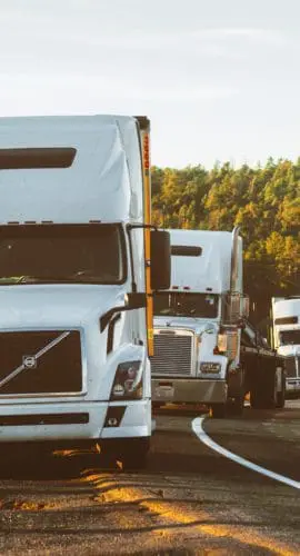 White volvo semi truck on side of road
