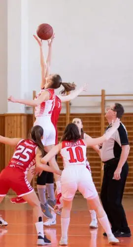 Women playing basketball