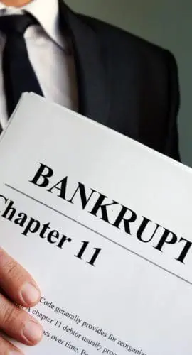 Man holds Bankruptcy Chapter 11 agreement documents.