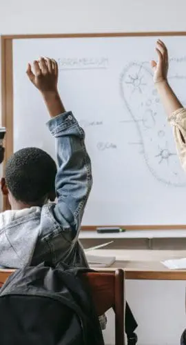 Black woman with pupils in classroom