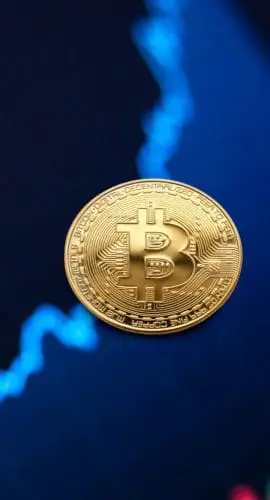 Gold bitcoin coin on background of growth chart