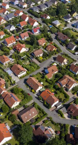 Aerial view above suburb homes in residential neighborhood.