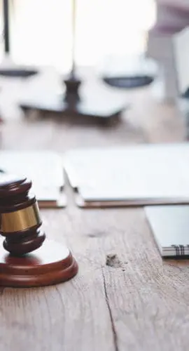Close-up of a judge with a hammer against the background of professional lawyer talking about a lawsuit. professional lawyers discussing legal case.