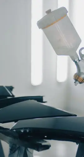 Close up of man painting car details