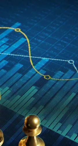 Golden chess pieces on a digital display with abstract financial charts and graphs