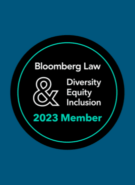 A circular badge with "Bloomberg Law & Diversity Equity Inclusion 2023 Member" written inside on a dark background.