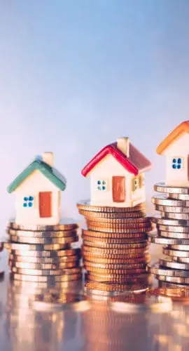 Miniature colorful house on stack coins using as property and financial concept