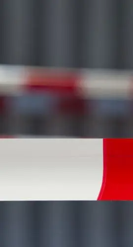 Red tape against dark background. Exclusion zone. Adobe RGB for better color reproduction.