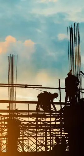 Silhouette of engineer and construction team working safely on scaffolding on high rise building. over blurred background sunset pastel for industry background with Light fair
