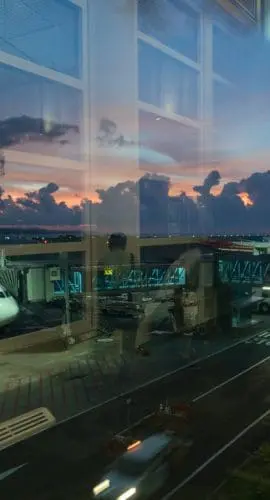 Aircraft on airfield through terminal window