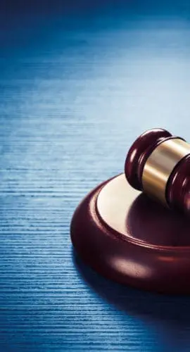 high contrast image of Judge gavel on a blue wooden background