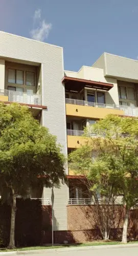 View of modern apartment building on a sunny day with warm lighting