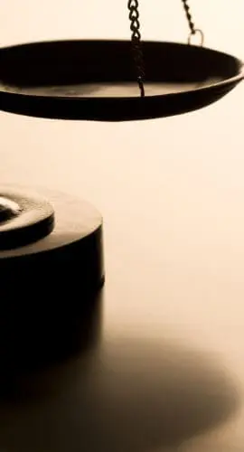 Scales of justice with back-light on wood table. Ideal for home page of law firm website. Can flop and add text as well.