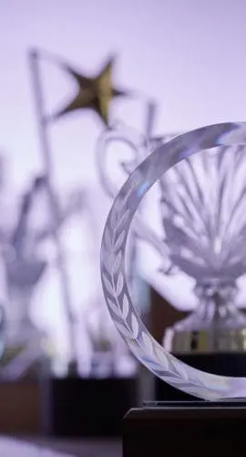 group of  crystal trophies against purple background