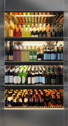 Glass door fridges photo mockup. Soda pop cans, vine and beer bottles in vertical freezer at airport restaurant.
Suitable for presenting new cans and bottles among many others.