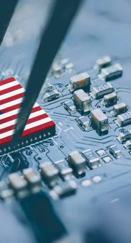 Flag of USA on a processor, CPU Central processing Unit or GPU microchip on a motherboard. Congress passes the CHIPS Act of 2022 to strengthen domestic semiconductor manufacturing, research and design.