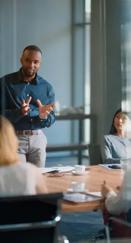 Businessman, meeting and discussion with office, boardroom and collaboration or workshop. Leader, training and presentation for mentor, coaching and strategy for teamwork and planning with startup