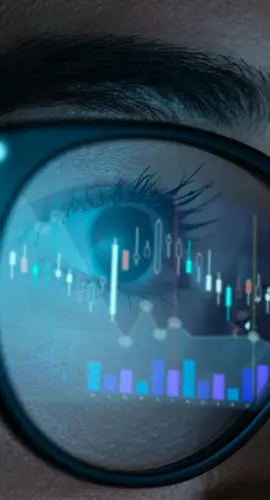 Female trader wearing eyeglasses with reflection of stock market charts