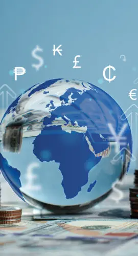 Crystal globe with symbols of international currencies including dollar, yen, yuan, euro, pound sterling, ruble and rupee placed on banknotes and stack of coins. World Bank ,Economic Inflation