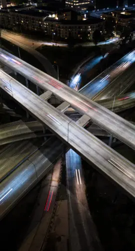 High angle aerial shot of Interstate 110 and US 101 in downtown Los Angeles, CA at night.