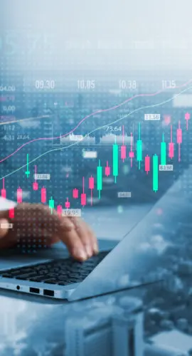 Investors use laptops to analyze stock market, investment strategies. and business growth analysis, investing in companies with long-term competitive advantages, against the backdrop of the city.